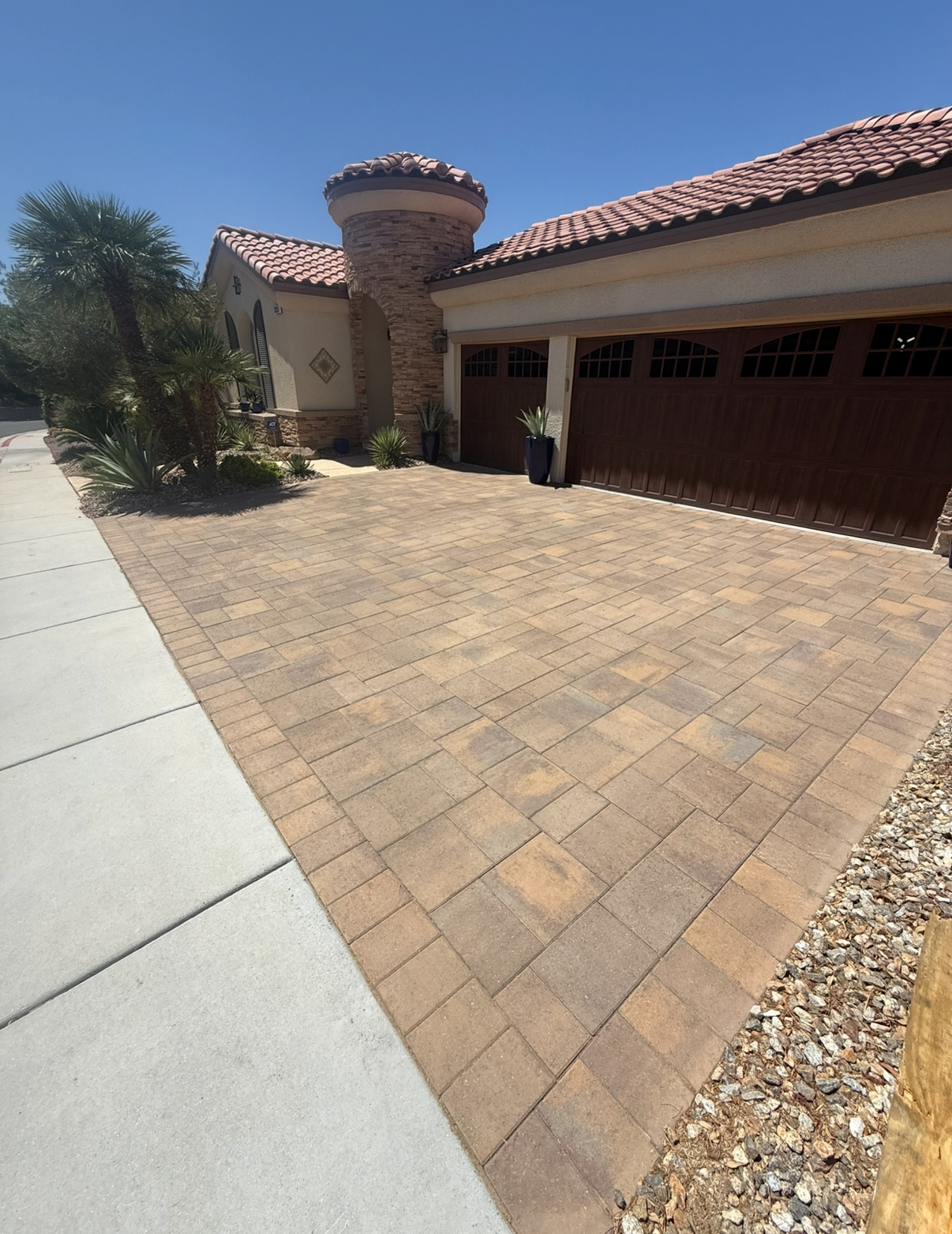 Faded and weathered paver driveway with visible staining before professional sealing in Las Vegas and Henderson.
